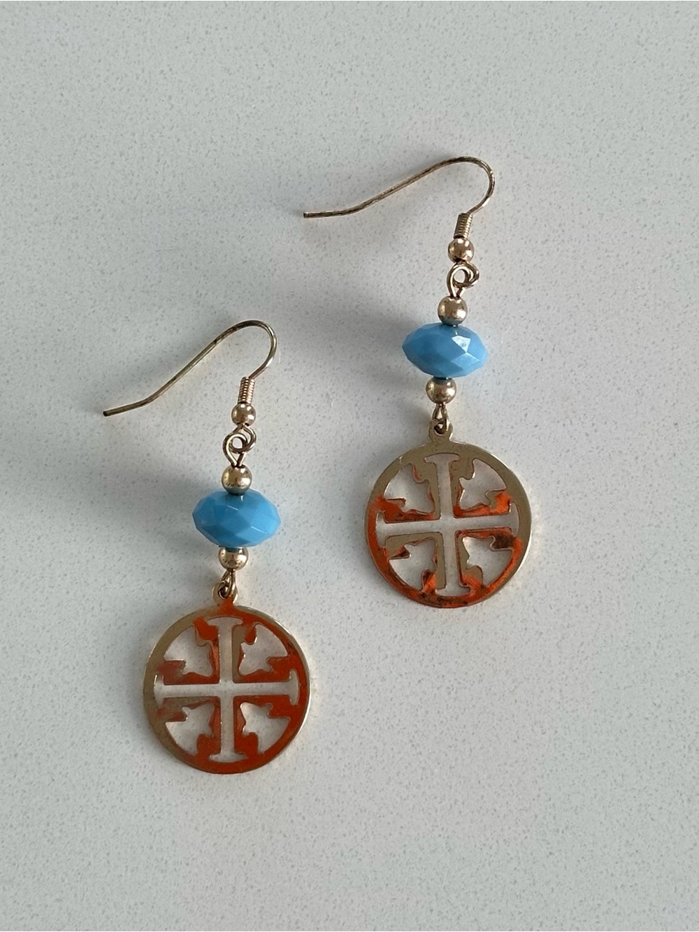 Tory Burch gold dangle earrings with blue bead detail